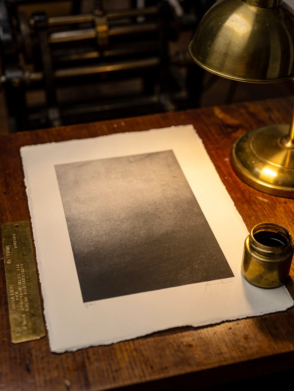 Fine art landscape print being inspected under studio lighting