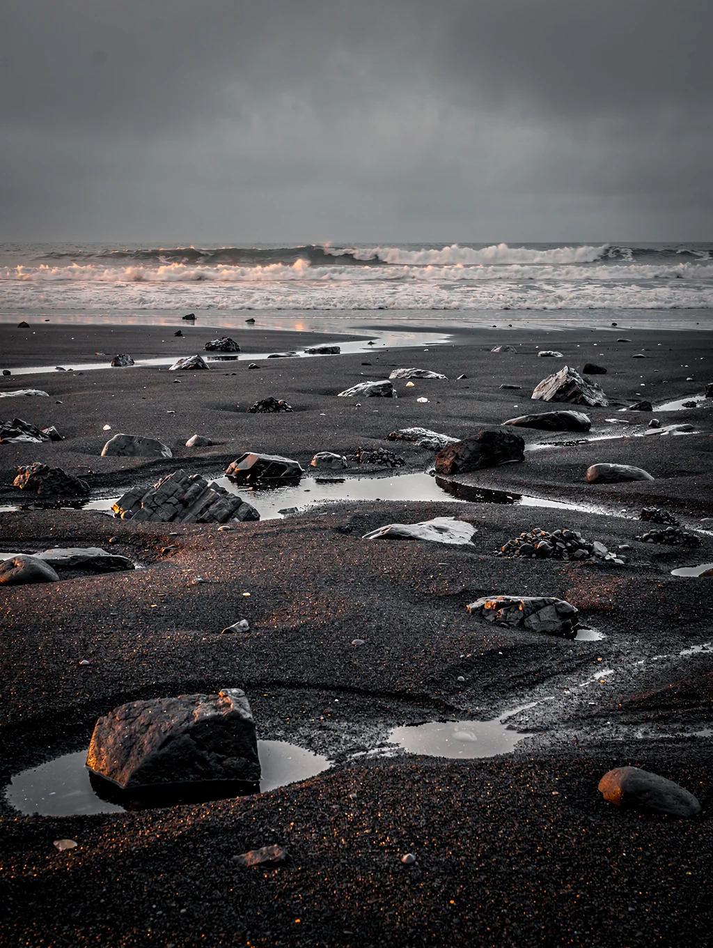 Black volcanic sand and glacial ice on Icelandic coast