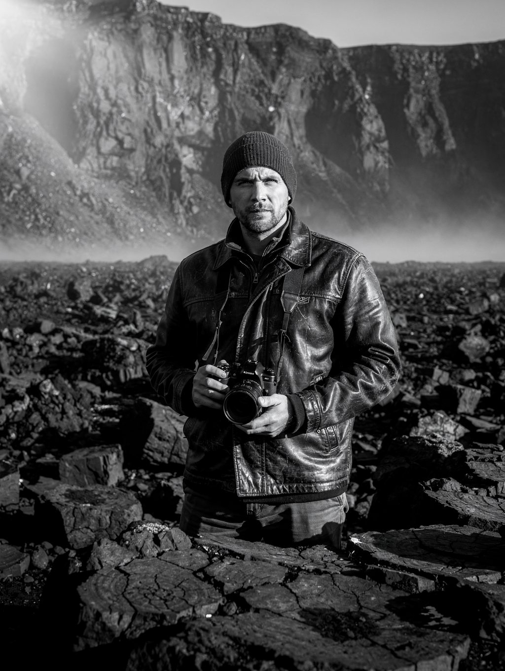 Photographer in field gear amidst Icelandic landscape